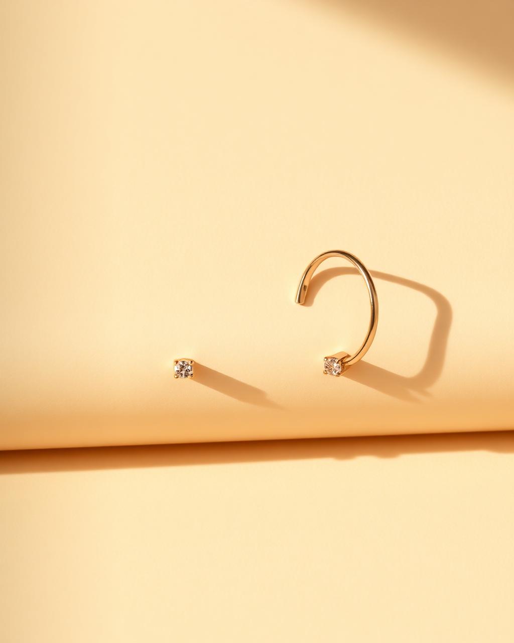 First Light Earrings — small gold hoops with one moissanite each.