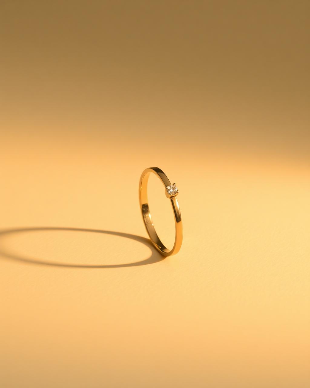 The Solstice Ring, a slender gold band with one small moissanite.